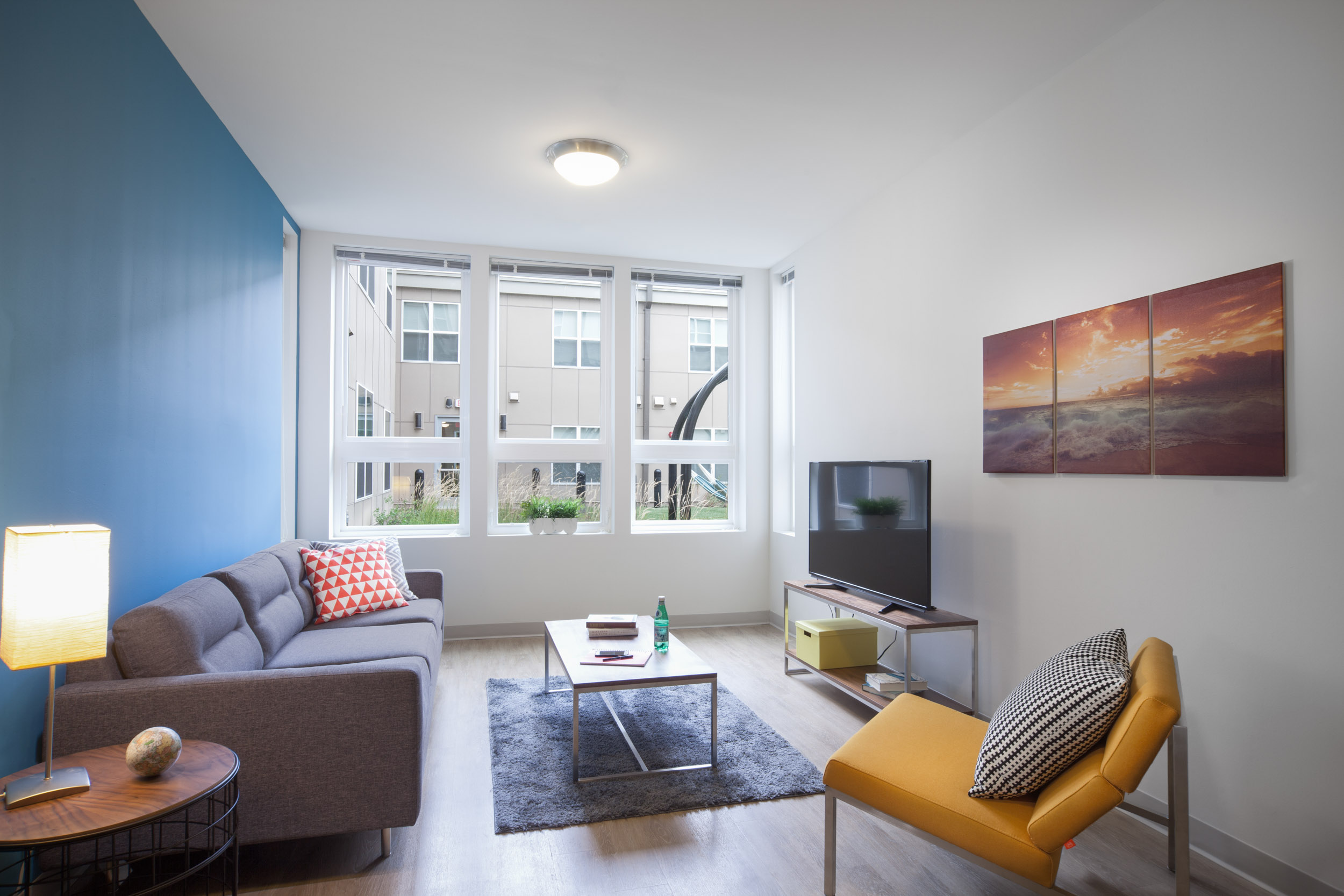 Living room with accent wall and big windows