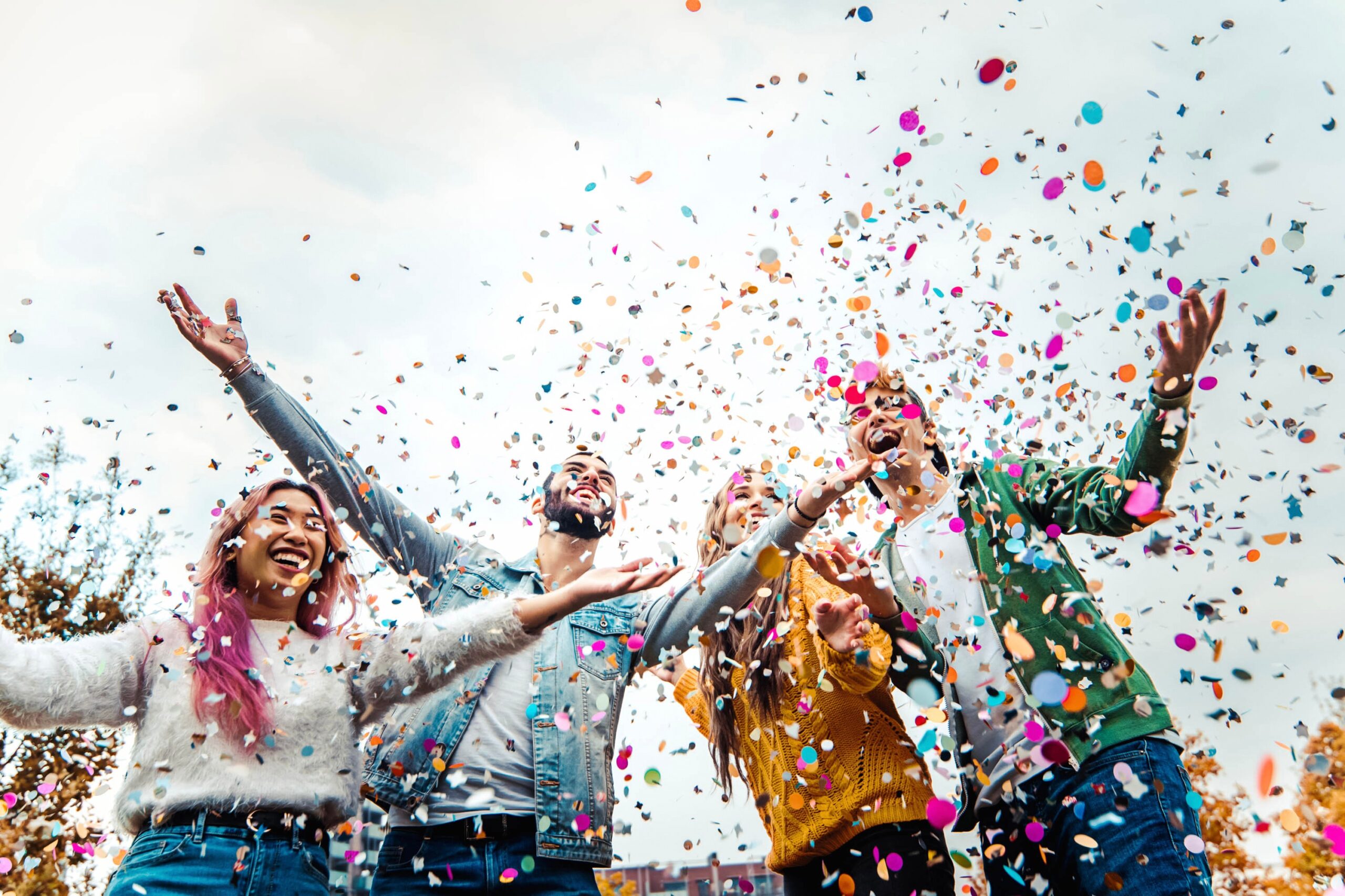 a group of people throwing confetti